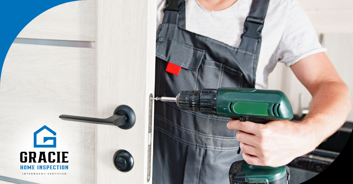 Person installing a modern black door handle on a wooden door using a drill